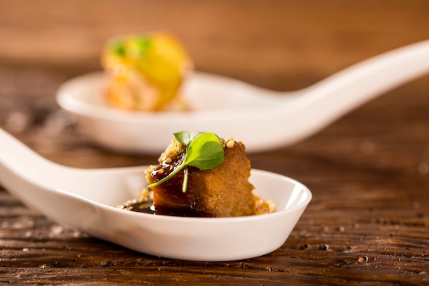 Pork tongue, ground banana, Marsala reduction, water meal and Mini watercress in a spoon. Taste gastronomy fingerfood