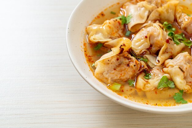 pork wonton soup or pork dumplings soup with roasted chili - Asian food style