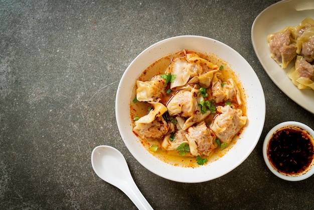 pork wonton soup or pork dumplings soup with roasted chili - Asian food style