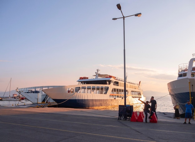 Port with ferryboat and port security at sunset on Greek island of Evia in Greece