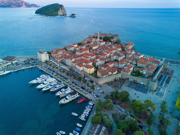 Port with ships and boats for excursions on the adriatic sea near the island of st stevan in the eve