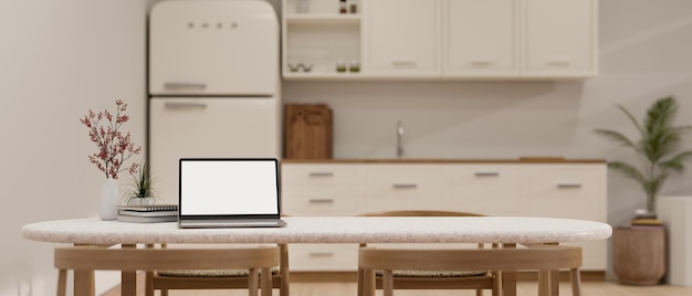 Portable laptop mockup decor and copy space on white dining table in minimal white kitchen