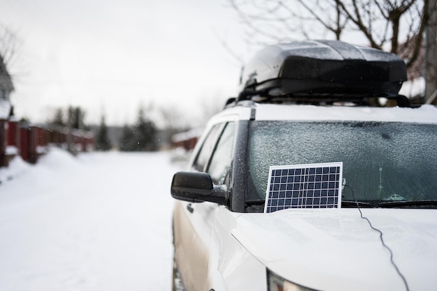 Portable solar panel on SUV car at winter