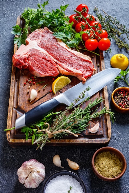 Porterhouse beef steak with herbs spices lemon