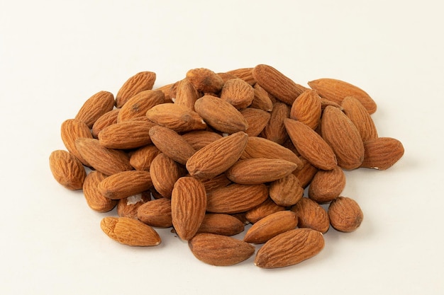 Portion of almonds isolated on white background Selective focus