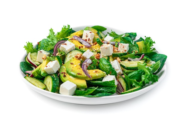 A portion of avocado salad with feta cucumber seeds and nuts on white Side view closeup