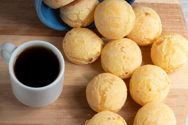 Portion of cheese bread pao de queijo with black coffee