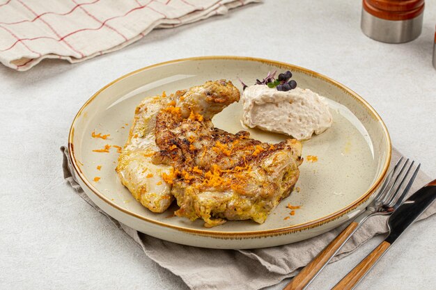 Portion of cooked chicken with nut cream