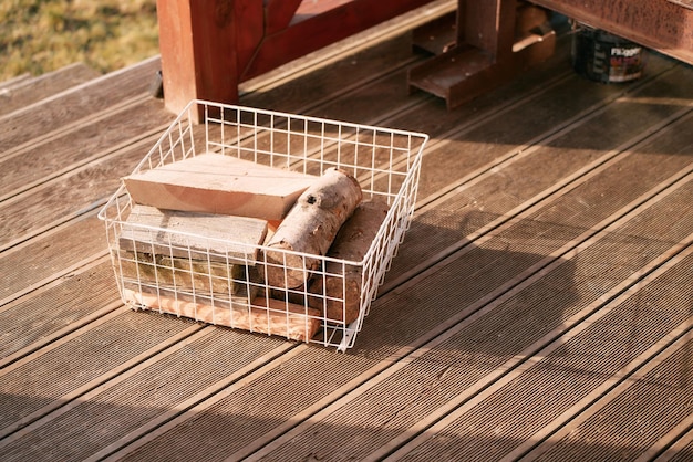 A portion of firewood in the white basket a small pile of firewood in reserve for the winter