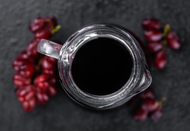 Portion of healthy Red Grape Juice selective focus closeup shot