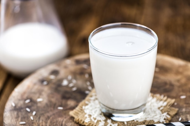 Portion of healthy Rice Milk on an old wooden table selective focus closeup shot