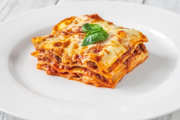 Portion of lasagne on white plate