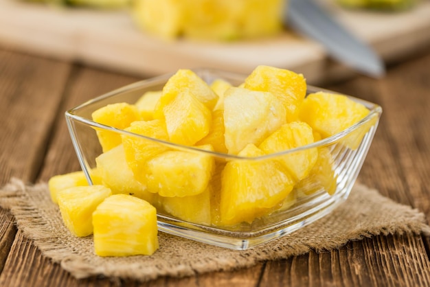 Portion of Pineapple sliced on wooden background selective focus