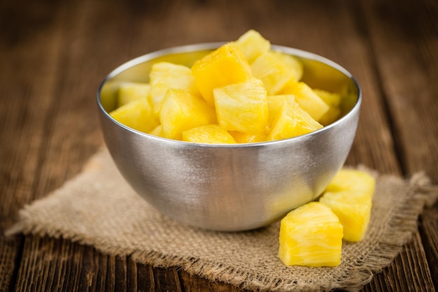 Portion of Pineapple sliced on wooden background selective focus