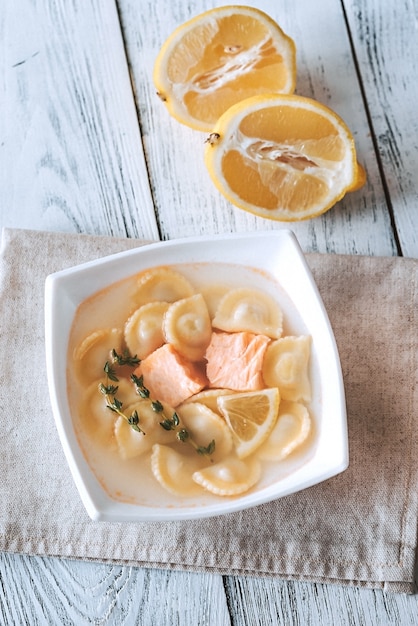 Portion of seafood ravioli soup