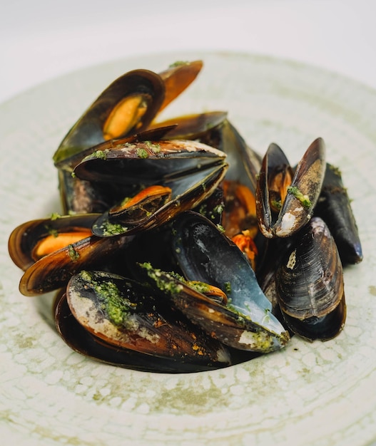 A portion of steamed mussels with garlic and parsley