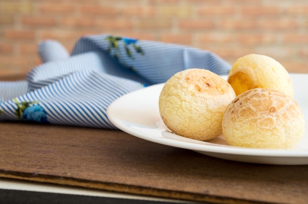 Portion with three cheese breads on the plate