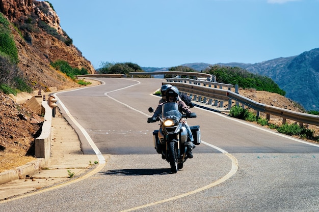 Porto Cervo, Italy - September 13, 2017: Motorcycle in the road in Costa Smeralda in Sardinia Island in Italy in summer. Motorcyclist driving scooter on highway in Europe. View on moped on motorway.