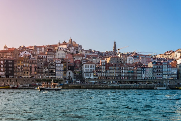 Porto Portugal Douro river with old boat and city skyline with colorful houses at summer sunset