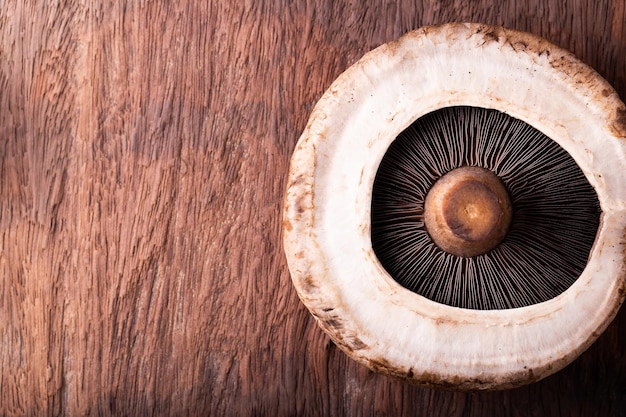 Portobello mushrooms over old wood background