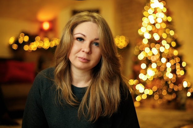 Portrait of a 30 year old beautiful woman in a festive new year interior