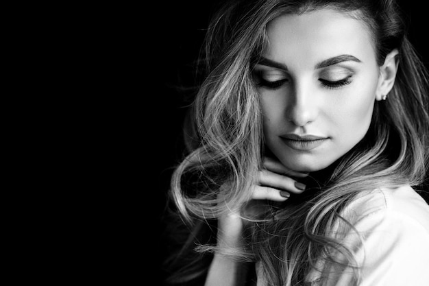 Portrait of a 36 year old woman with curly hair and brown slanting eyes Soft selective focus Black and white art photo