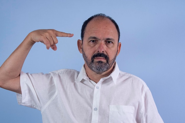 Portrait of 60 years old bearded man on blue background