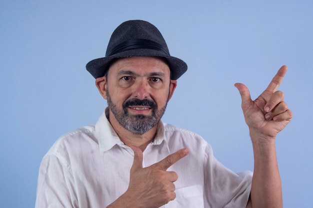 Portrait of 60 years old bearded man on blue background