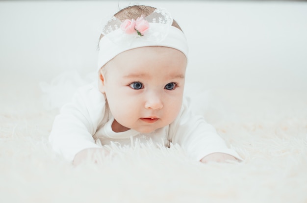 Portrait of an adorable girl lying on her belly close-up portrait