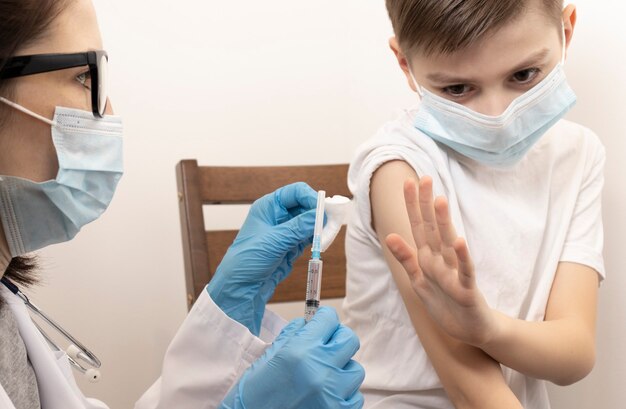 Portrait of adorable little boy being vaccinate at doctor's office