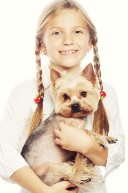 Portrait of an adorable young girl smiling holding a cute puppy