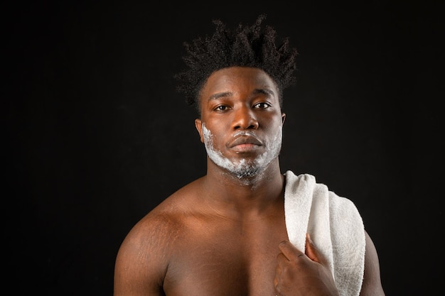 portrait of an adult african man on a black background