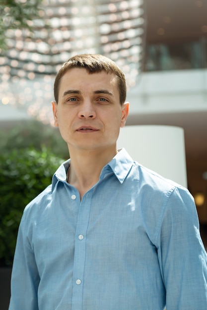 Portrait of an adult Caucasian man with a blue shirt.