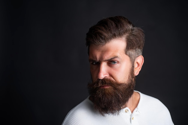 Portrait of adult man of Caucasian appearance isolated on black background Closeup face of bearded man on black background professional studio light