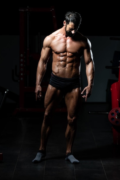 Portrait Of A Adult Physically Fit Man Showing His Well Trained Body - Muscular Athletic Bodybuilder Fitness Model Posing After Exercises