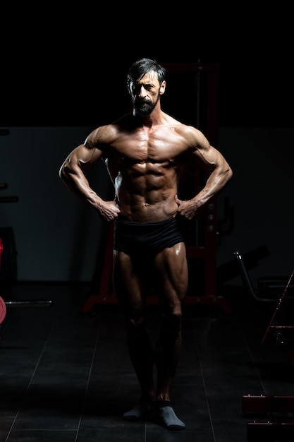 Portrait Of A Adult Physically Fit Man Showing His Well Trained Body - Muscular Athletic Bodybuilder Fitness Model Posing After Exercises