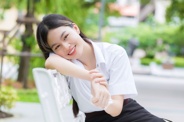 Portrait of adult Thai student in university student uniform