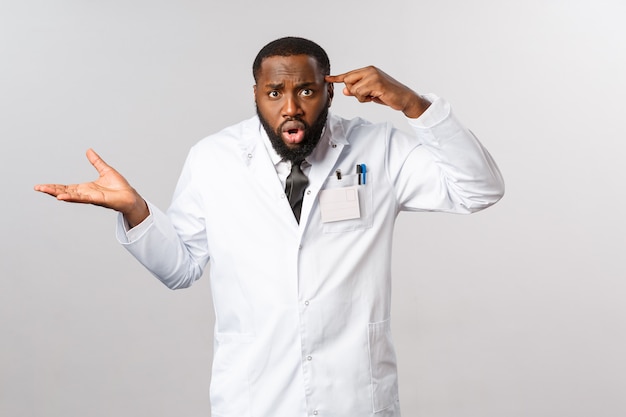 Portrait African American Doctor in white uniform.