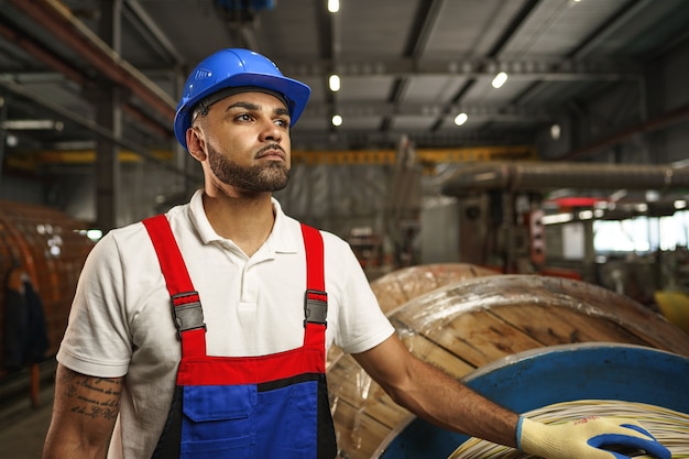 Portrait of african american male handyman working in an industrial factory