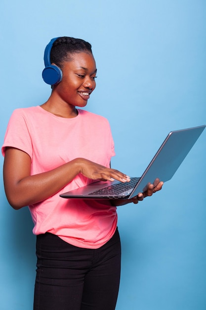 Portrait of african american student with headphones listening music