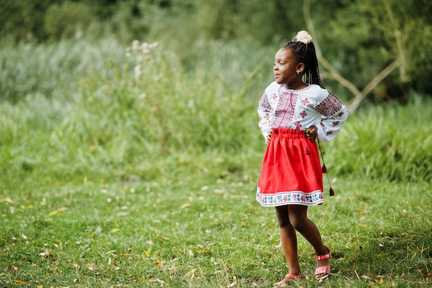 Portrait of african girl kid in traditional clothes at park.