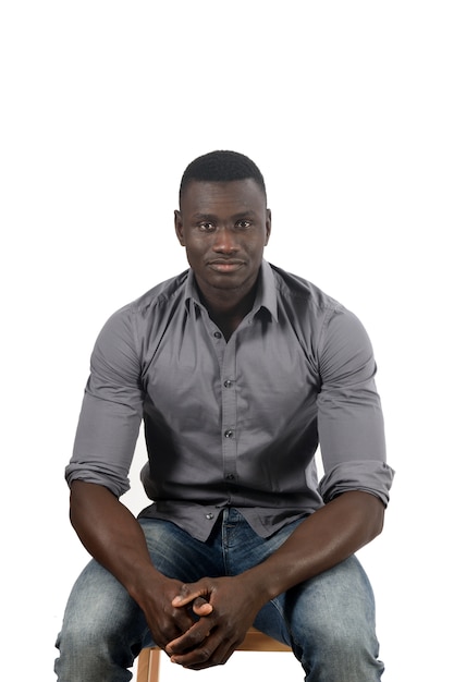 Portrait of a african man sitting on white