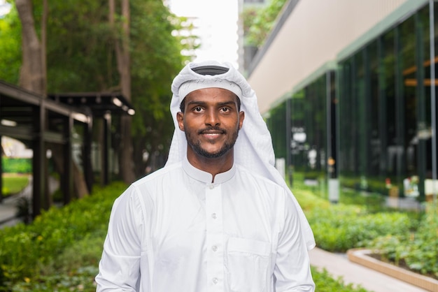 Portrait of African Muslim man wearing religious clothing an scarf outdoors