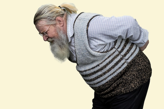 Photo portrait of aged senior man suffering from backache isolated on white background