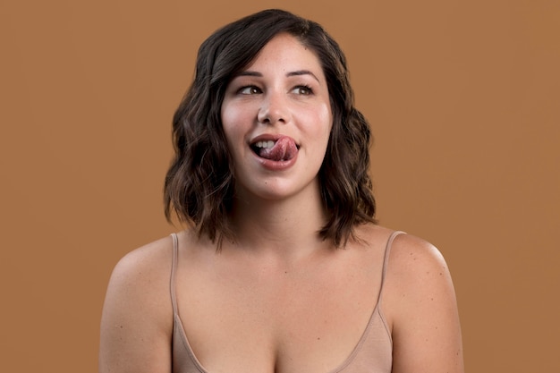 Portrait of alluring woman with tongue out