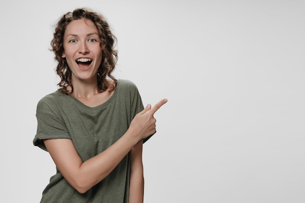 Portrait of amazed woman with opens eyes and mouth widely stupefied expression