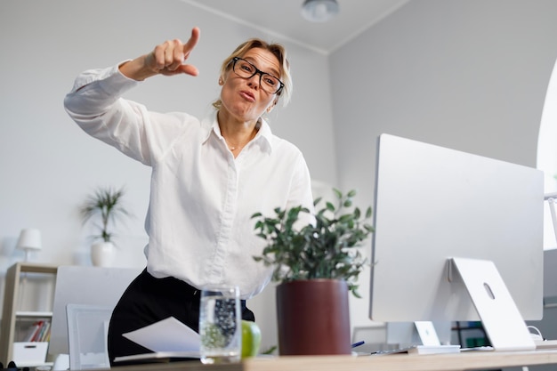 Portrait of angry businesswoman screaming and pointing fingers