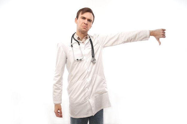 Portrait of angry doctor in white medical coat with stethoscope upset face screaming on white background with copy space