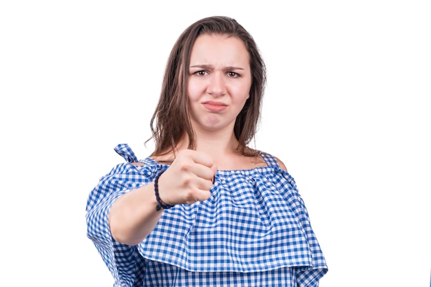 Portrait of an angry woman showing a fist at the camera, isolated on a white background