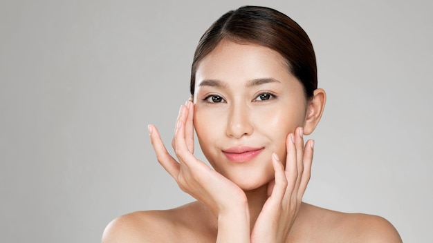 Portrait of ardent young woman posing beauty gesture with clean fresh skin